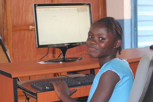 Girl receiving computer training computer lab Sierra Leone