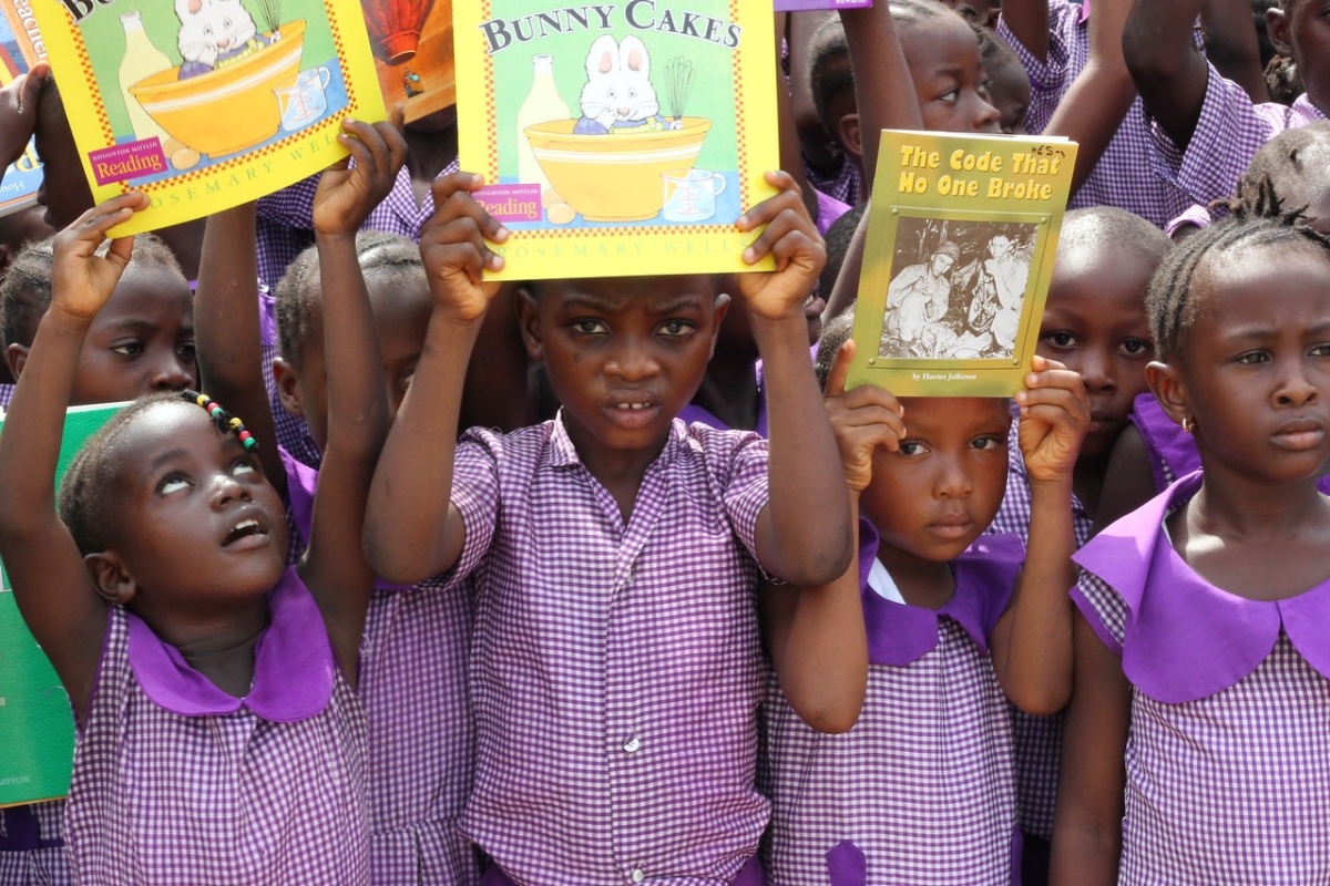 children with books at a school in Sierra Leone