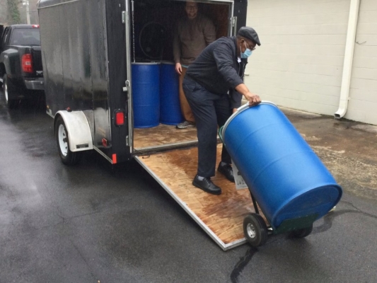 Man pulling a big blue drum