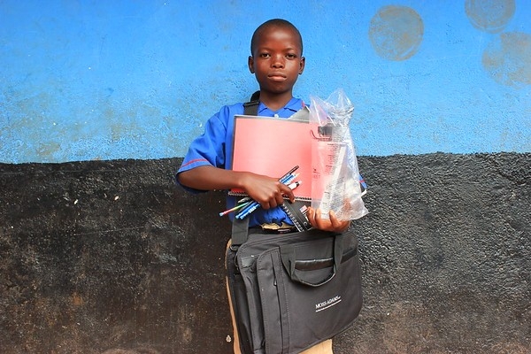 A young boy with his school things