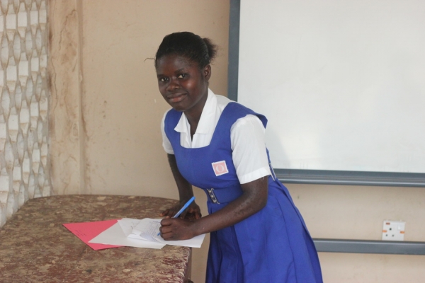 Isata in her uniform writing