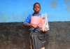 A young boy with his school things