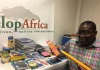 Sylvester, the CEO of Develop Africa with the donated school supplies