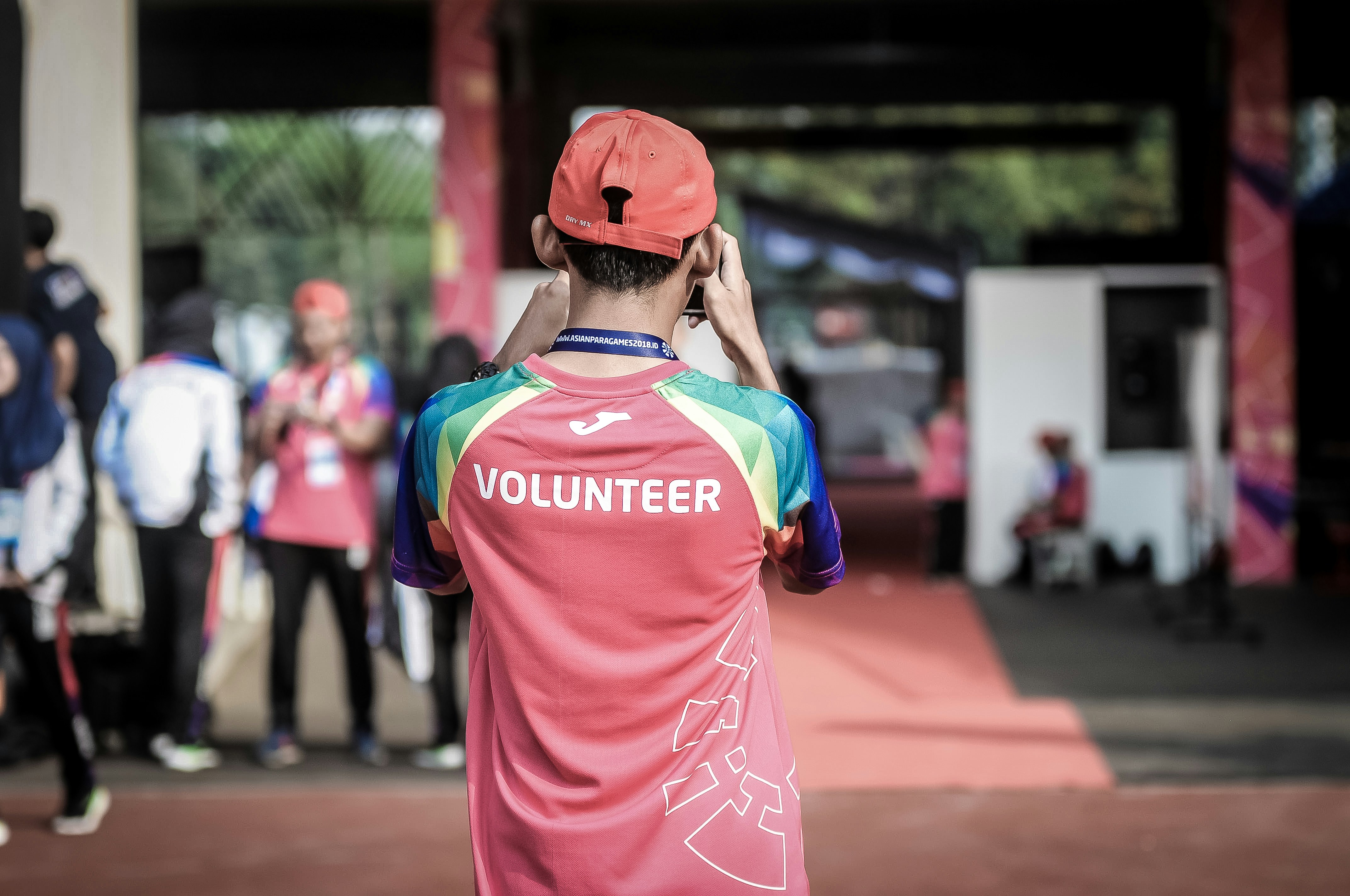 person standing wearing red t-shirt