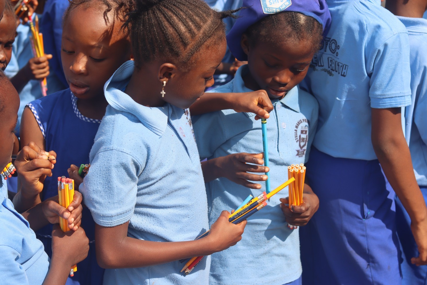 (c) Develop Africa. Pupuils with pencils provided to them by Develop Africa.