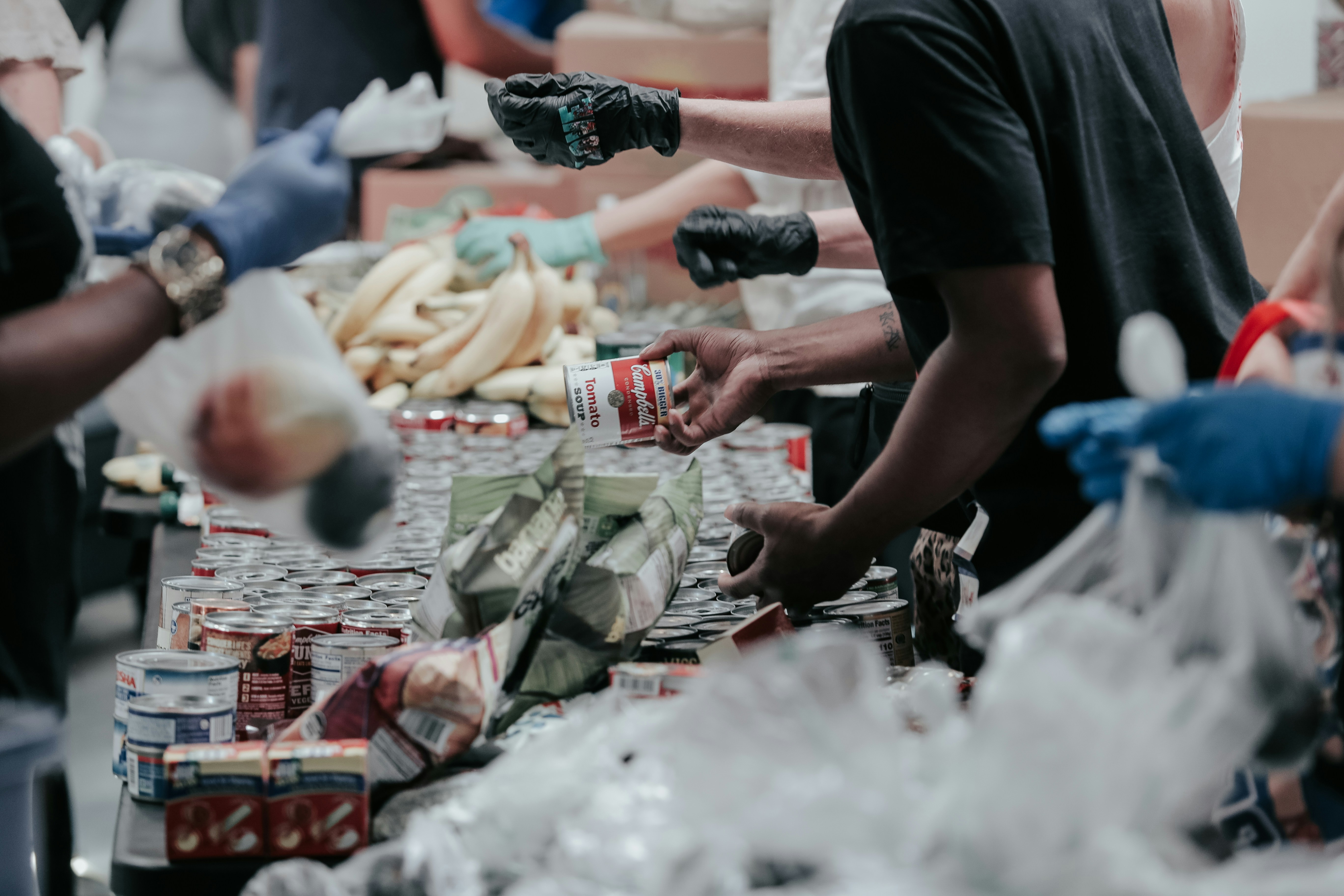 man in black t-shirt holding campbell's can